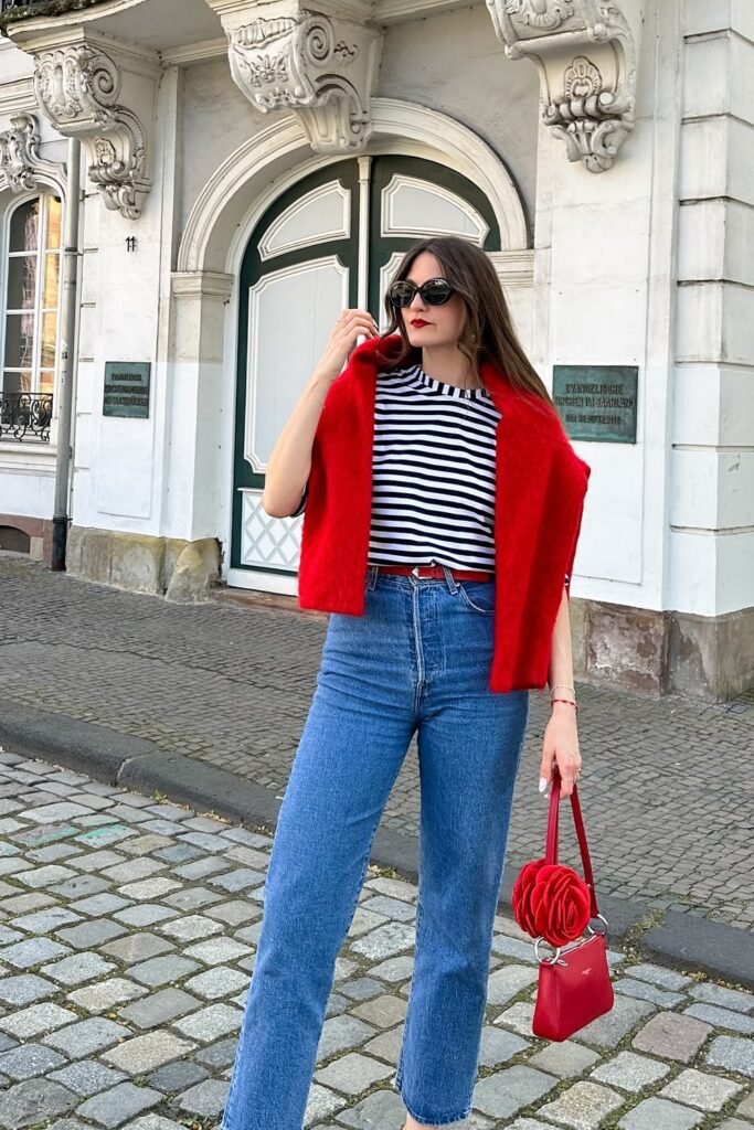 Red Sweater + Black & White Striped Top + Straight-Leg Jeans + Red Handbag