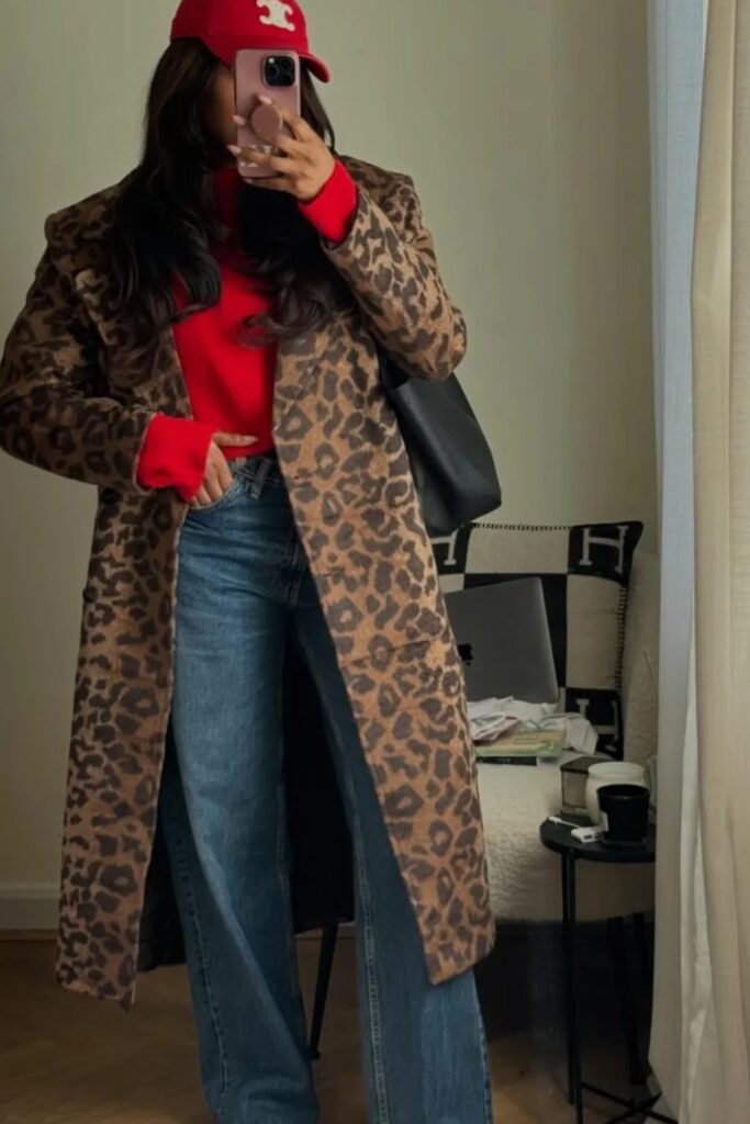 Red Sweater + Leopard Print Long Coat + Blue Wide-Leg Jeans + Red Cap + Black Tote Bag