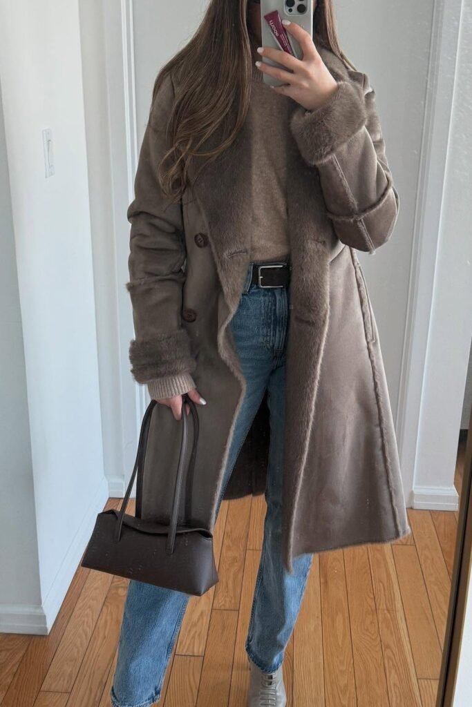 Taupe Shearling Coat + Taupe Knit Sweater + Straight-Leg Blue Jeans + Brown Belt + Brown Mini Tote + Beige Sneakers