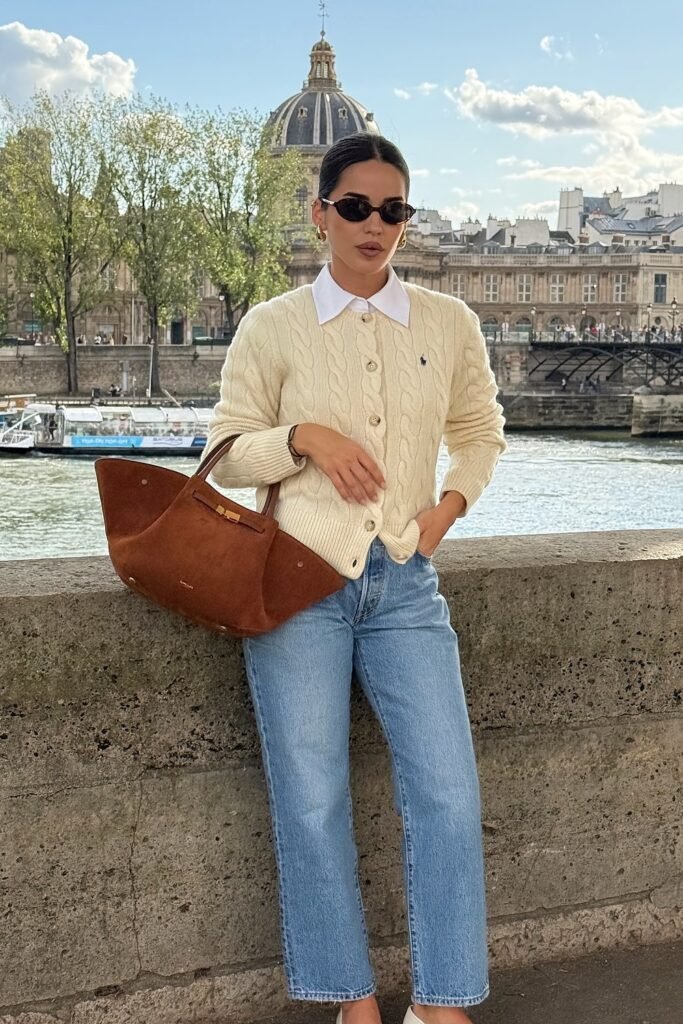 Cream Cable Knit Sweater + Blue Jeans + White Sneakers + Brown Handbag