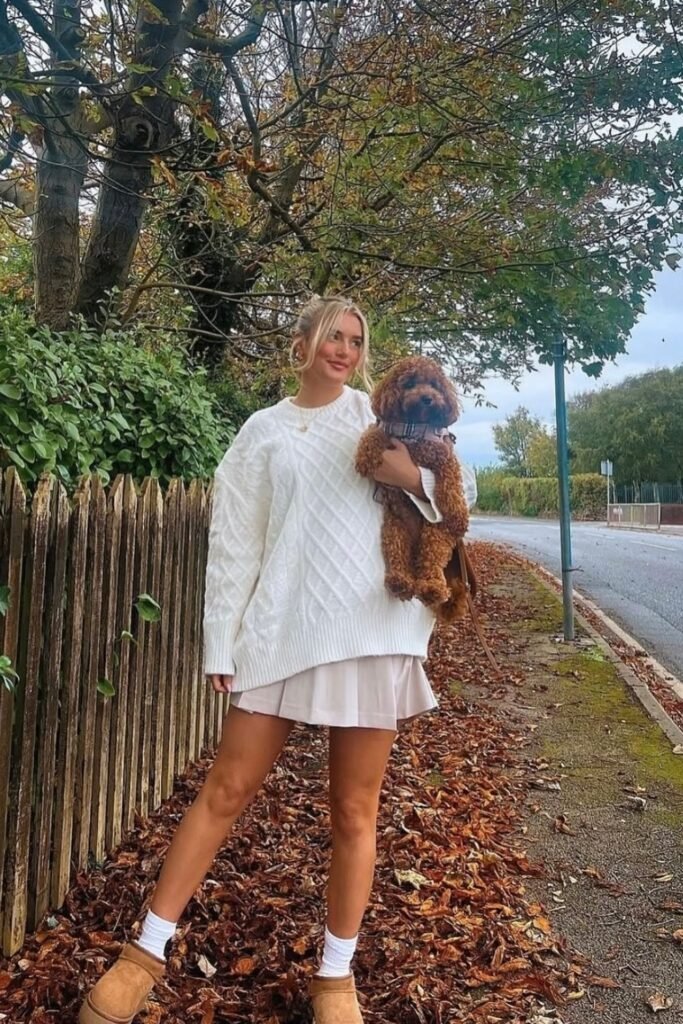 White Oversized Cable Knit Sweater + Pleated Mini Skirt + White Socks + Tan UGG Slippers