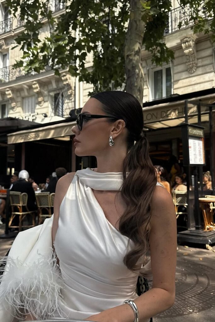White Satin Asymmetric Top with Draped Scarf Detail + White Feather-Trimmed Jacket (draped) + Silver Jewelry
