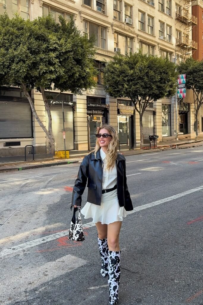 White Shirt Dress + Black Cropped Leather Jacket + Cow Print Knee-High Boots + Cow Print Bag