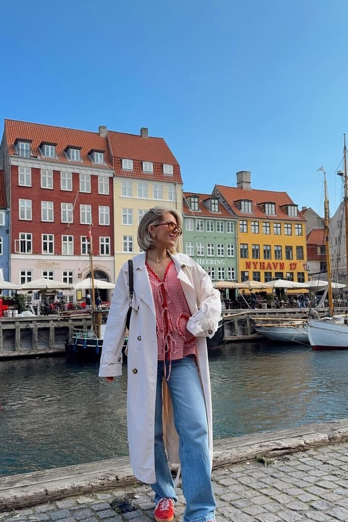 White Trench Coat + Red Gingham Button-Up Blouse + Light Wash Jeans + Red Sneakers + Sunglasses