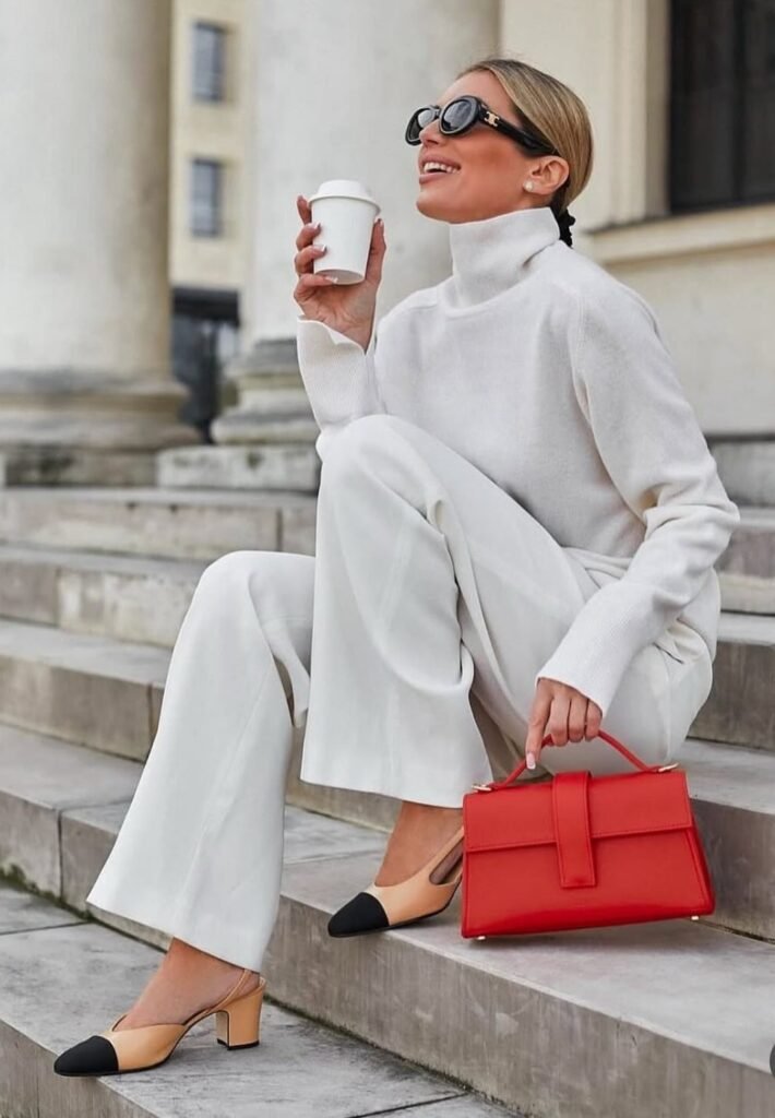 White Turtleneck Sweater + White Flared Pants + Black and Beige Heels + Red Handbag