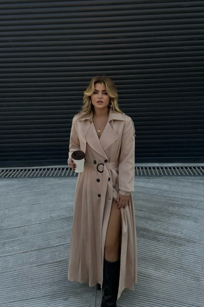 Beige Belted Trench Coat + Gold Necklace + Black Knee-High Boots + Coffee Cup Accessory