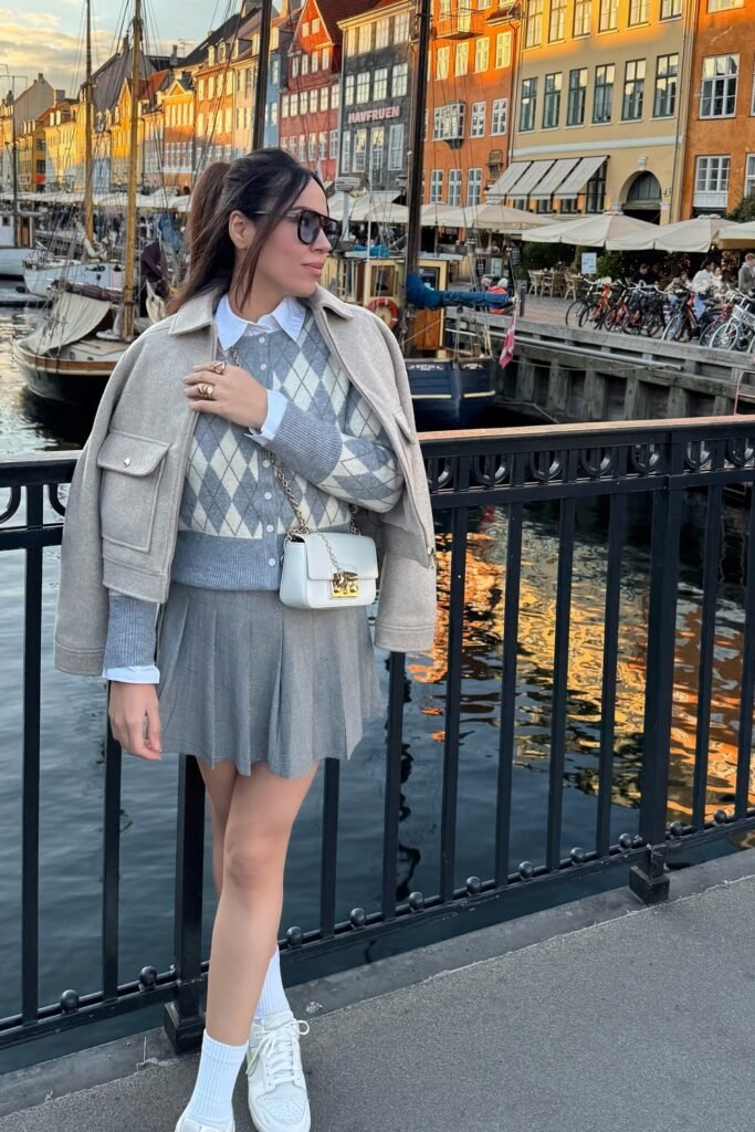 Beige Cropped Jacket + Argyle Sweater Vest/Cardigan + Grey Pleated Mini Skirt + White Sneakers