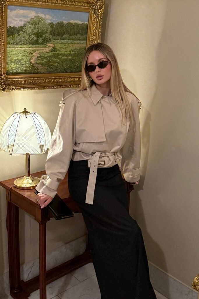 Beige Cropped Trench Coat + Black Maxi Skirt + Black Cat-Eye Sunglasses