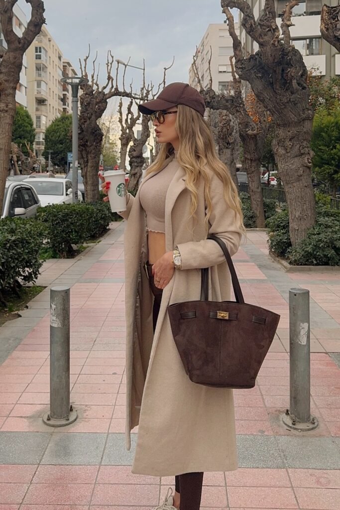 Beige Long Coat + Taupe Cropped Top + Dark Leggings + Brown Baseball Cap