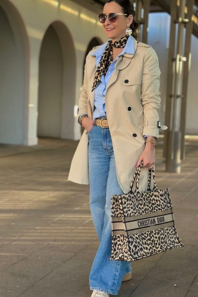 Beige Trench Coat + Light Blue Shirt + Light Blue Wide-Leg Jeans + Animal Print Scarf + Tote Bag