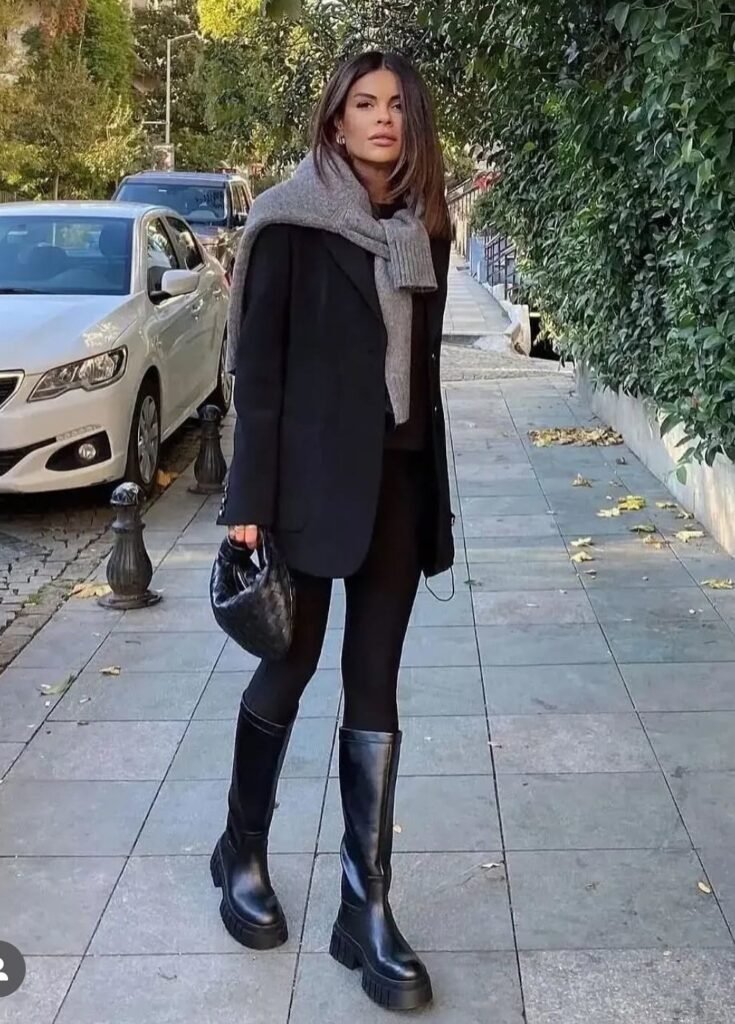 Black Blazer + Grey Scarf (Draped) + Black Top + Black Leggings + Black Knee-High Combat Boots
