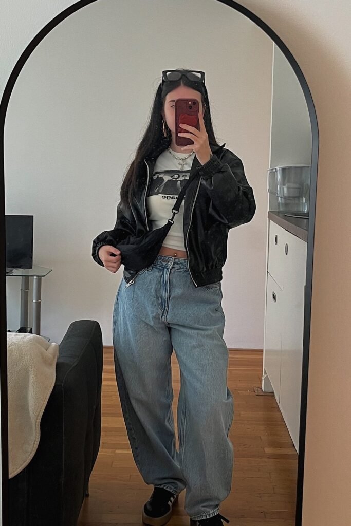 Black Bomber Jacket + Light Wash Baggy Jeans + White Graphic Crop Top