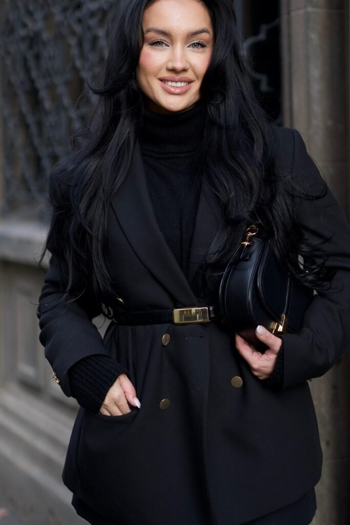 Black Double-Breasted Blazer + Black Turtleneck Sweater + Black Belt with Gold Buckle + Black Bag
