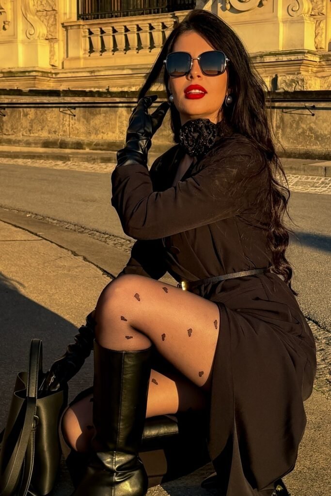 Black Dress with Belt + Heart-Patterned Sheer Tights + Black Knee-High Boots + Black Leather Gloves + Oversized Sunglasses
