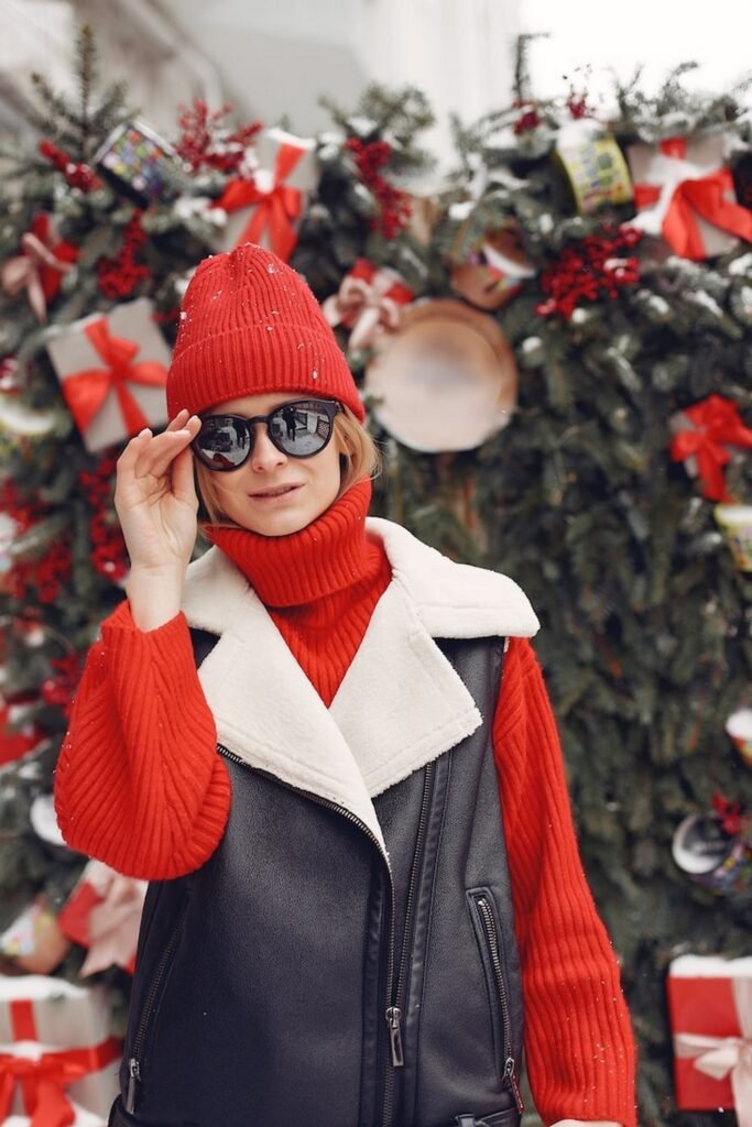 Black Faux Leather Vest with Sherpa Collar + Red Turtleneck Sweater + Red Knit Beanie