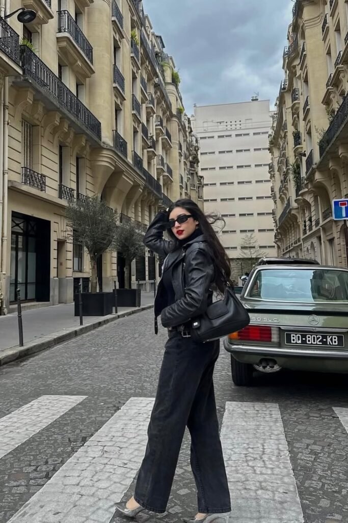 Black Leather Biker Jacket + Black Turtleneck + Black Wide-Leg Jeans + Black Shoulder Bag