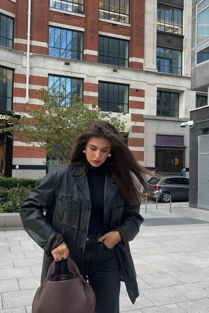 Black Leather Jacket + Black Turtleneck + Black Jeans + Brown Handbag