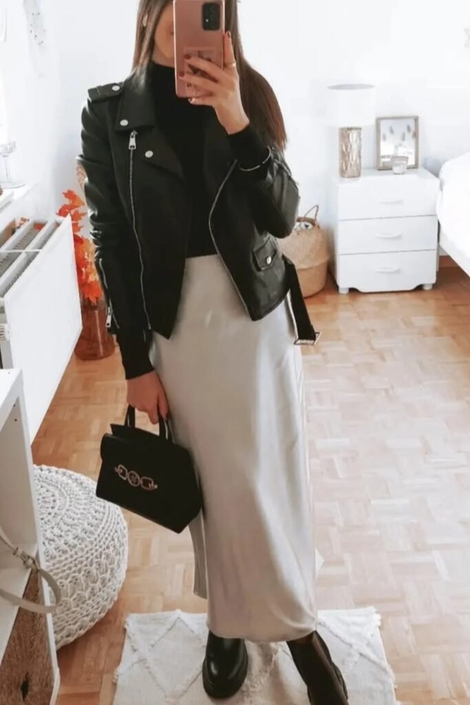 Black Leather Jacket + Black Turtleneck + Silver/Light Gray Satin Midi Skirt + Black Ankle Boots + Black Top-Handle Bag
