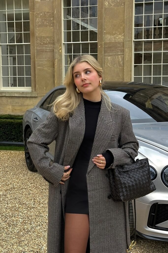 Black Long Coat + Black Mini Dress + Black Sheer Tights + Black Woven Handbag + Gold Earrings