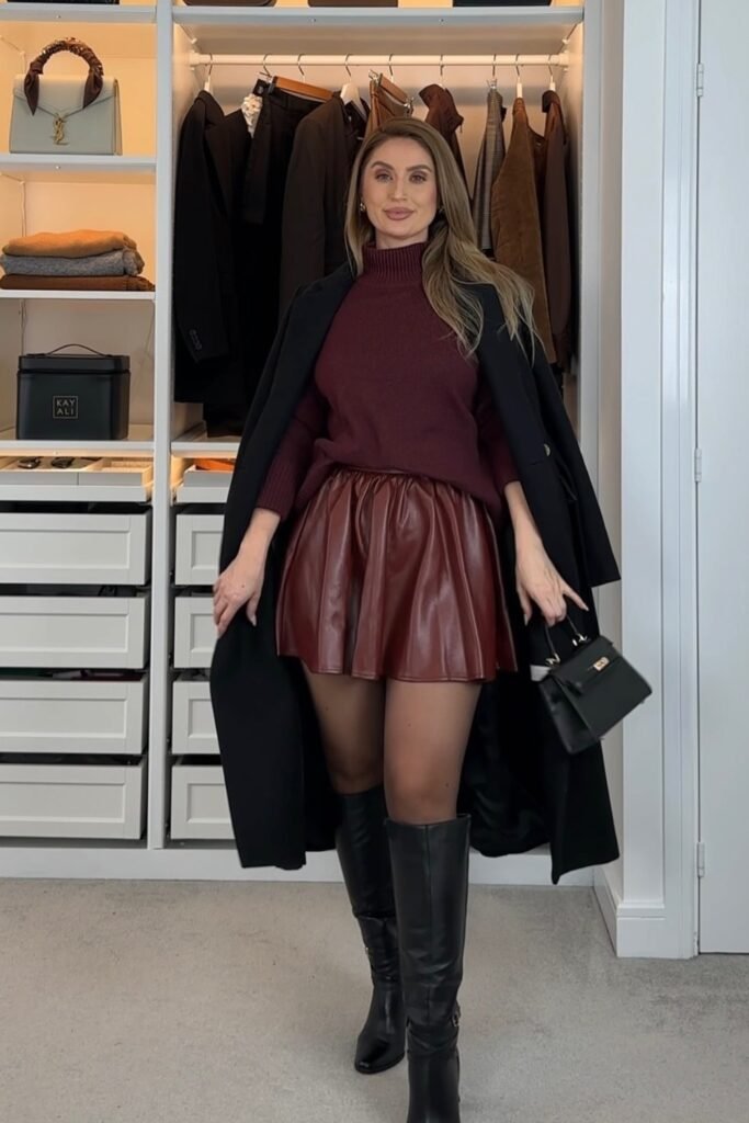 Black Long Coat + Burgundy Turtleneck Sweater + Red Faux Leather Mini Skirt + Black Tights + Black Knee-High Boots