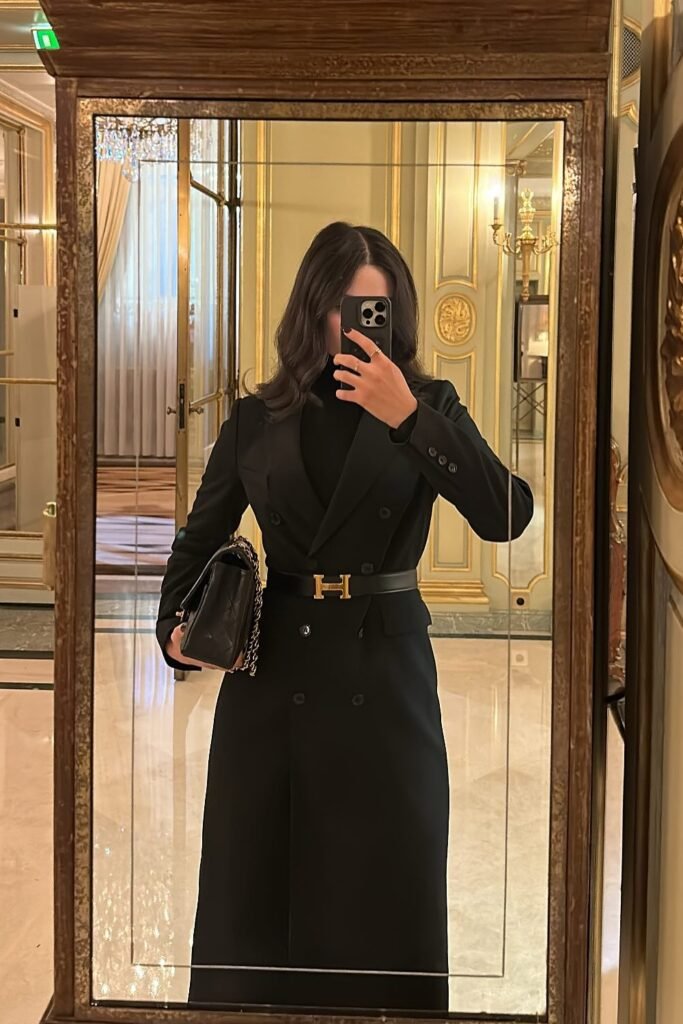 Black Long Double-Breasted Coat/Blazer (Belted) + Black Turtleneck + Gold "H" Belt + Quilted Black Chain Bag