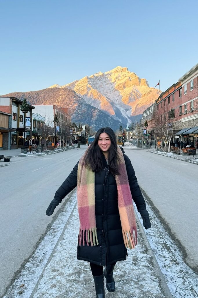 Black Long Puffer Coat + Plaid Fringe Scarf + Black Boots