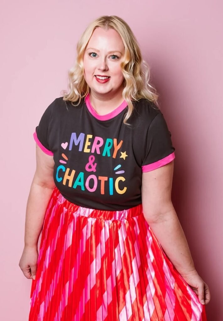 Black 'Merry & Chaotic' Graphic Tee + Pink & Red Pleated Metallic Skirt