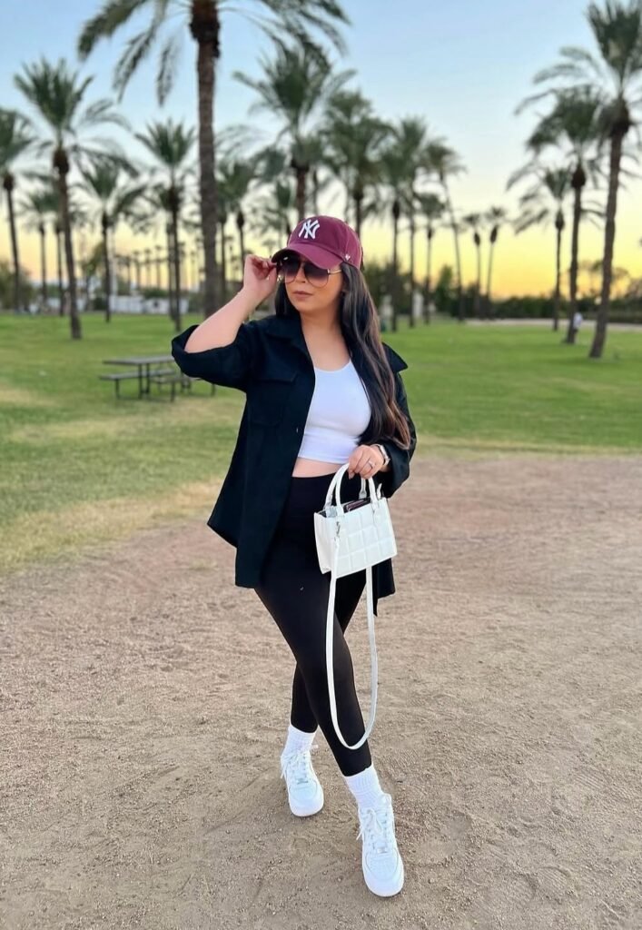 Black Overshirt + White Crop Top + Black Leggings + White Sneakers + Burgundy Cap + White Mini Handbag