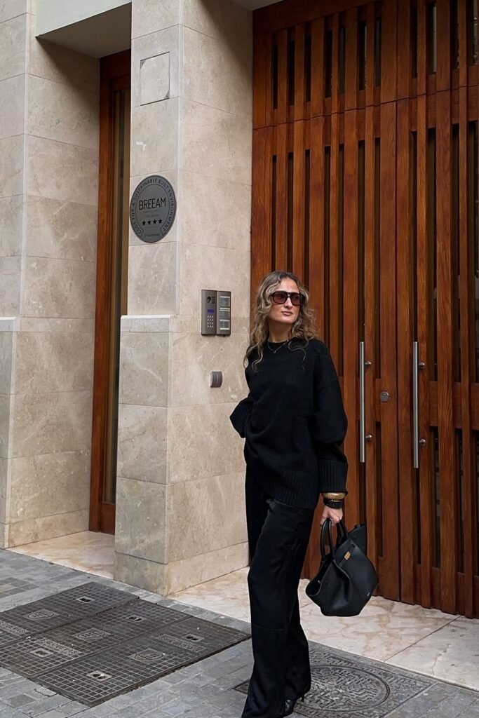 Black Oversized Sweater + Black Wide-Leg Pants + Black Structured Handbag + Sunglasses