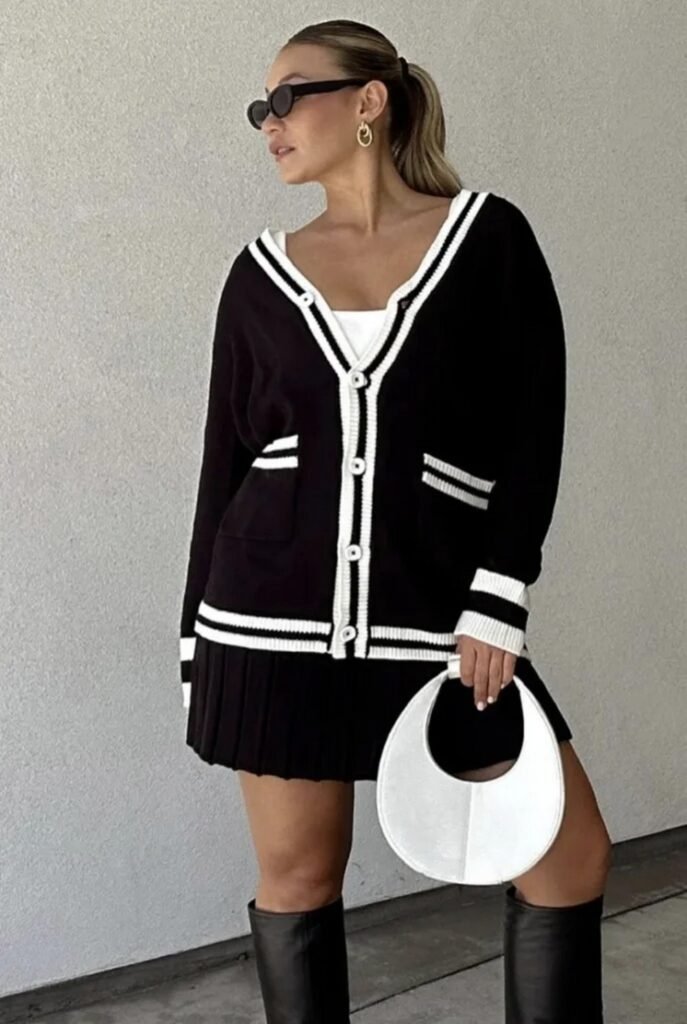 Black Striped Cardigan + White Pleated Mini Skirt + Over-the-Knee Black Boots + White Handbag