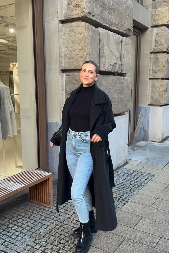 Black Tie-Waist Coat + Black Turtleneck + Light Wash Skinny Jeans + Black Lug Sole Boots