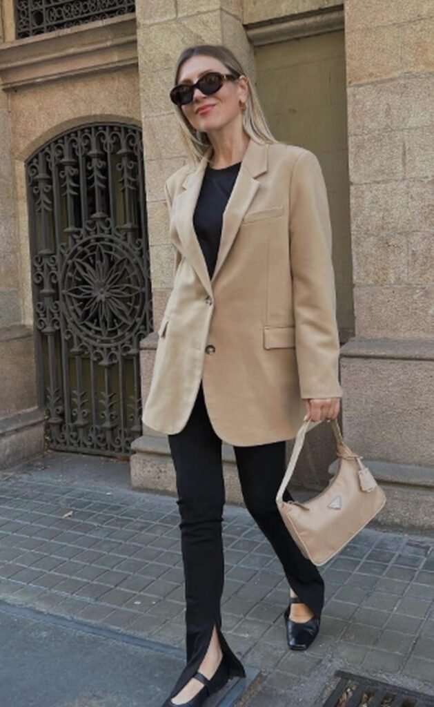 Black Top + Tan Oversized Blazer + Black Split-Hem Flared Pants + Black Ballet Flats + Tan Handbag