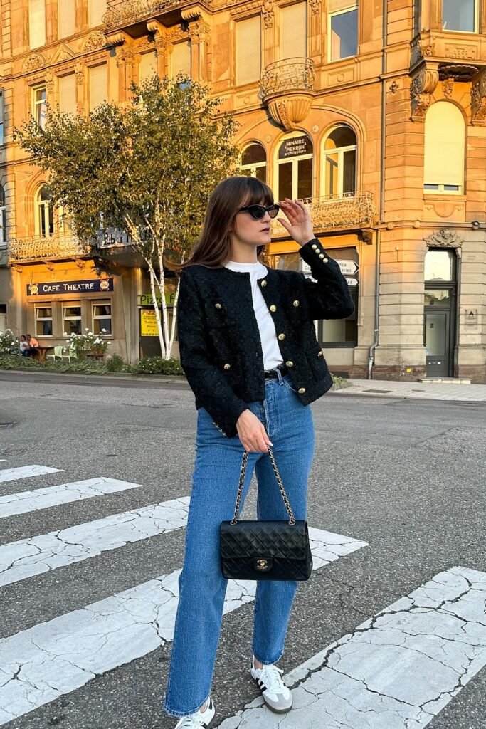Black Tweed Jacket with Gold Buttons + White T-Shirt + Blue Straight Jeans + White Sneakers + Black Quilted Chain Bag + Black Sunglasses