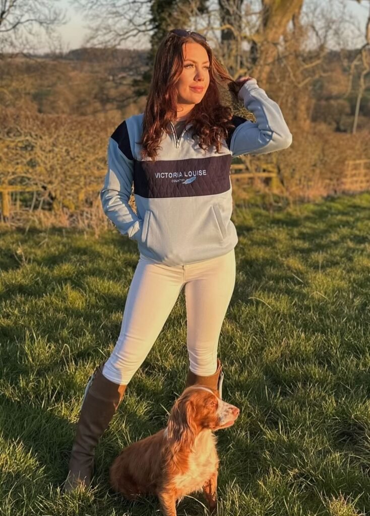 Blue and Navy Block Quarter-Zip Sweatshirt + Cream Equestrian Breeches + Brown Riding Boots