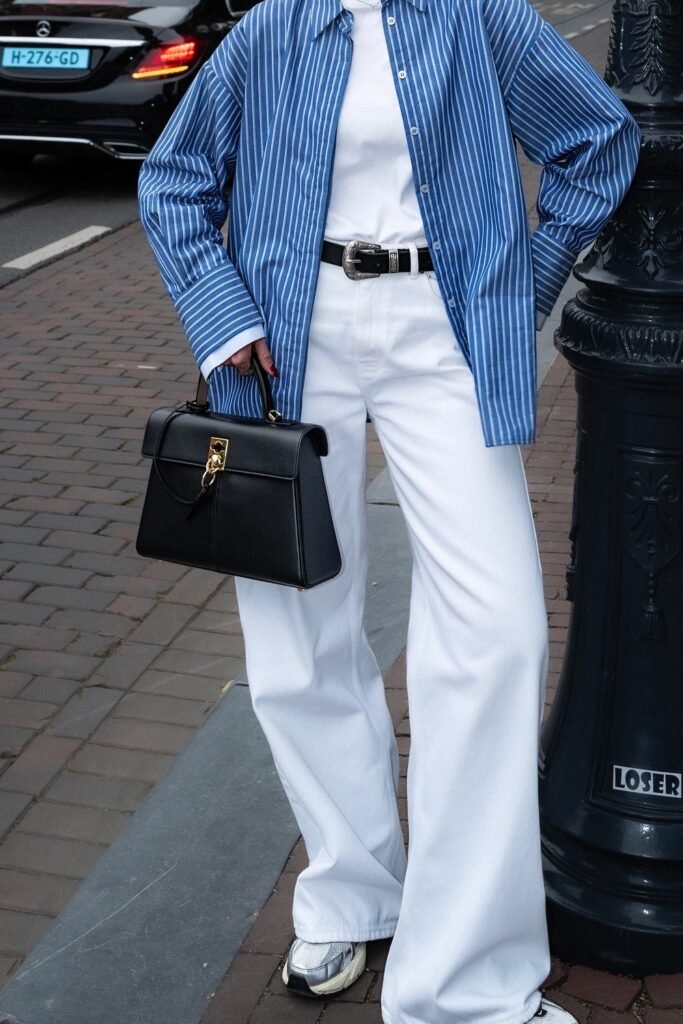 Blue and White Striped Shirt + White T-Shirt + White Wide-Leg Jeans + Black Handbag + Sneakers