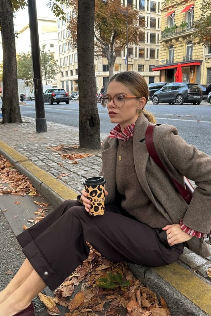Brown Blazer + Brown Knit Sweater + Red and White Ruffle-Neck Blouse + Dark Brown Cropped Trousers + Burgundy Crossbody Bag