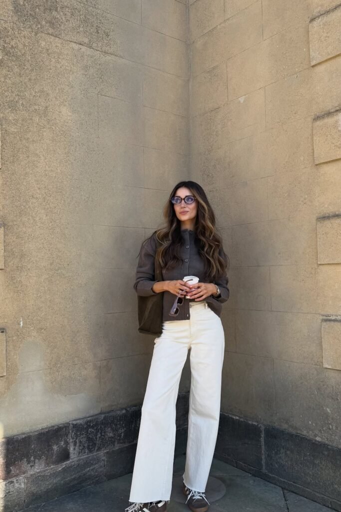 Brown Button-Up Overshirt + Cream Wide-Leg Jeans + Dark Sneakers + Dark Sunglasses