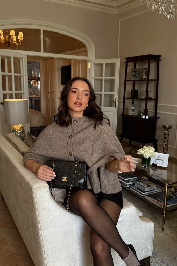 Brown Suede Vest + Black Turtleneck + Black Pleated Mini Skirt + Black Sheer Tights + Black Knee-High Boots