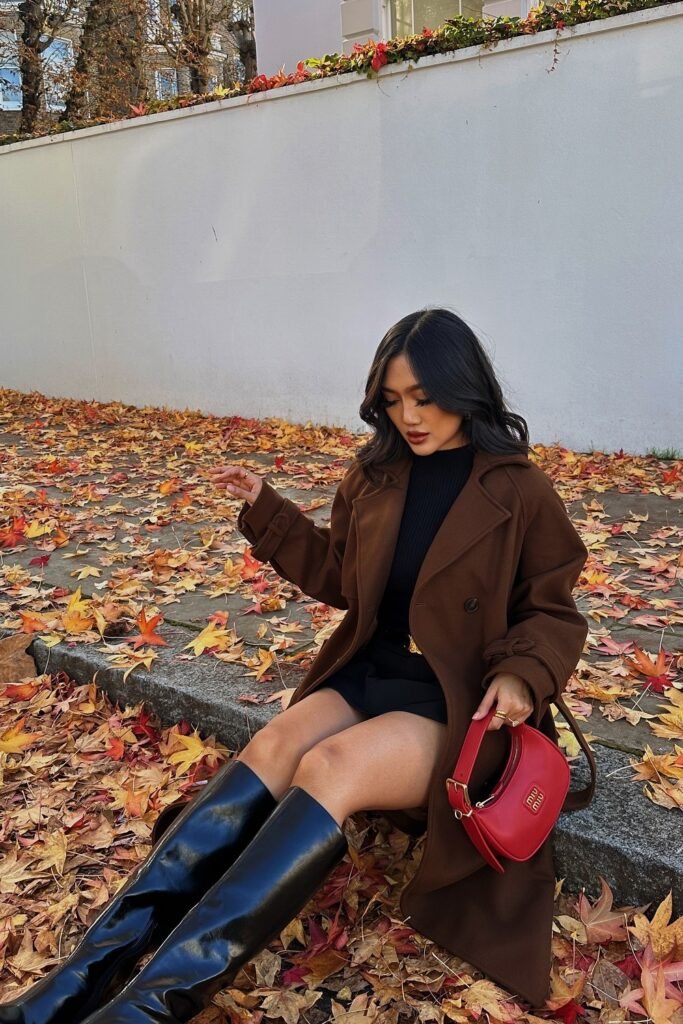 Brown Coat + Black Ribbed Sweater + Black Mini Skirt + Black Knee-High Boots + Red Mini Handbag