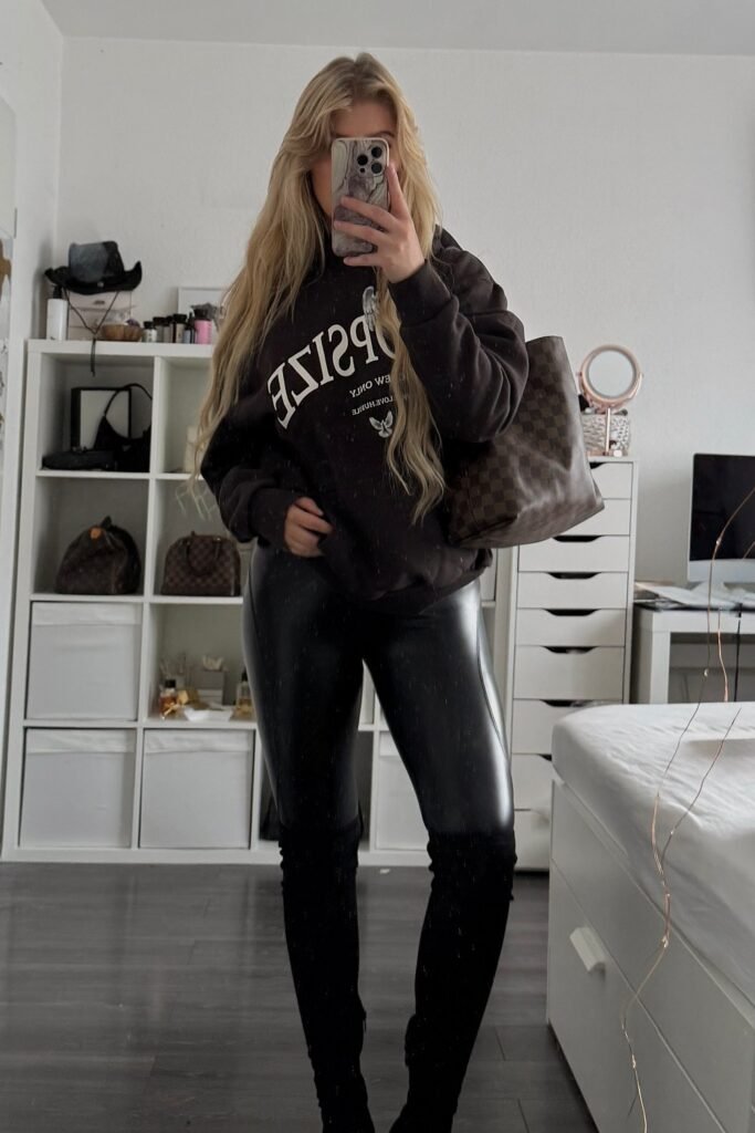Brown Graphic Sweatshirt + Black Faux Leather Leggings + Black Over-the-Knee Boots + Logo Tote Bag