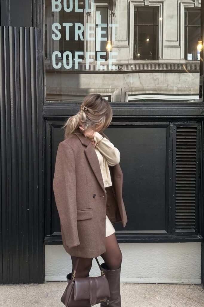 Brown Oversized Blazer + Cream Cardigan + White Mini Skirt + Black Opaque Tights + Dark Brown Knee-High Boots