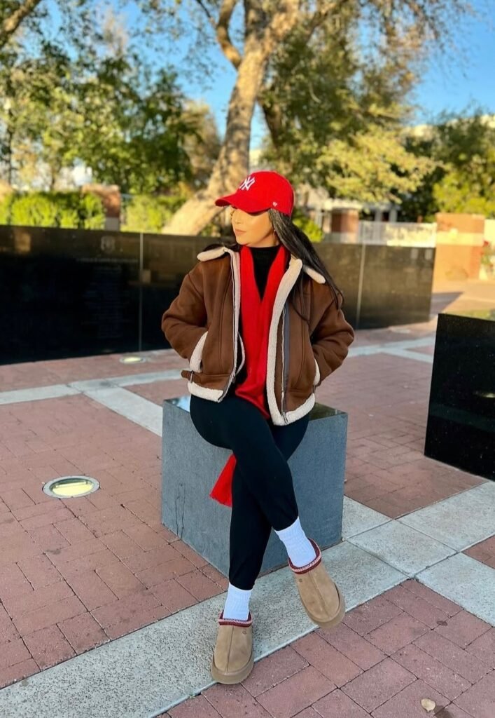 Brown Shearling Jacket + Black Sweater + Black Leggings + Red Scarf + Red Cap + Tan Slippers