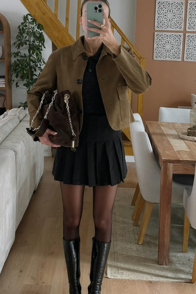 Brown Suede Cropped Jacket + Black Knit Polo Shirt + Black Pleated Mini Skirt + Black Knee-High Boots