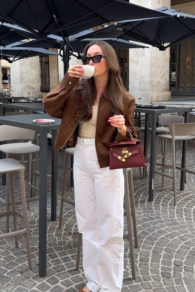 Brown Suede Jacket + Cream Tank Top + White Wide-Leg Jeans + Burgundy Mini Bag