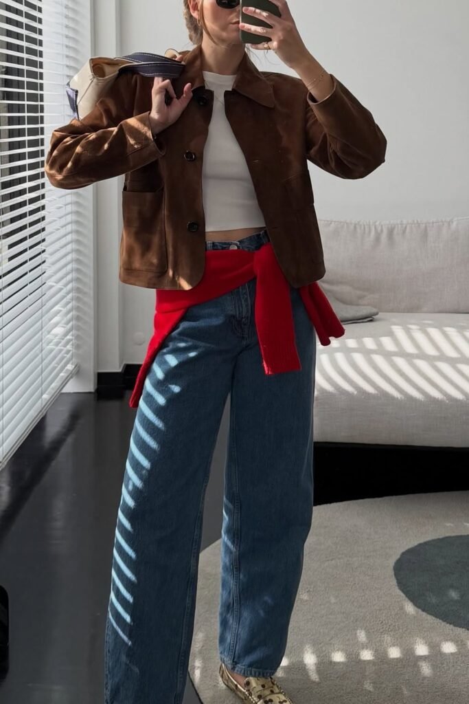 Brown Suede Jacket + White Top + Medium Wash Wide-Leg Jeans + Red Sweater Accent