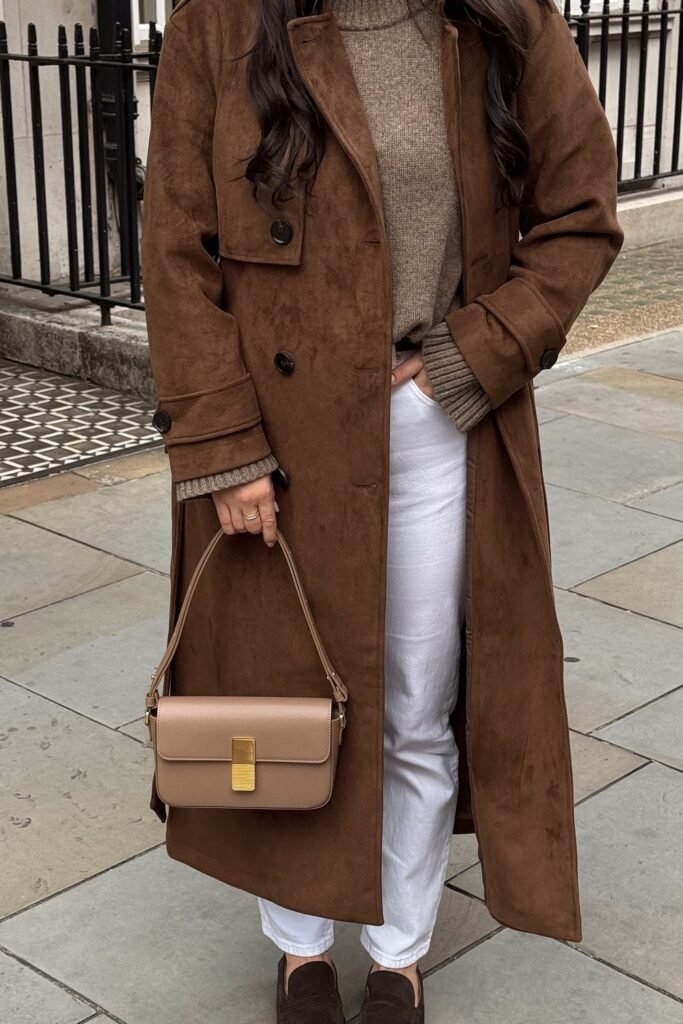 Brown Suede Trench Coat + Tan Knit Sweater + White Straight-Leg Trousers + Brown Loafers + Tan Crossbody Bag