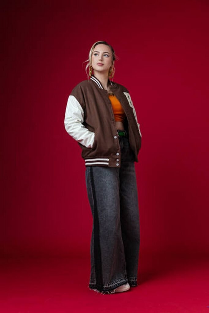 Brown and White Varsity Jacket + Dark Wash Baggy Jeans + Orange Crop Top