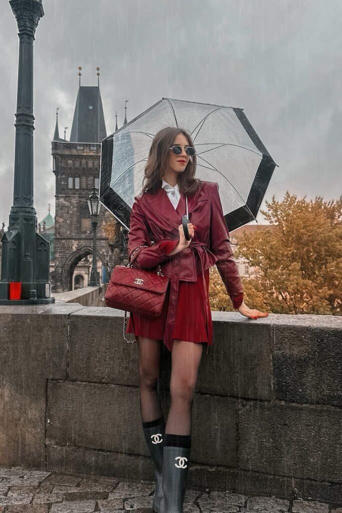Burgundy Leather Jacket + White Shirt + Red Mini Skirt + Black Sheer Tights + Black Chanel Rain Boots + Burgundy Quilted Bag