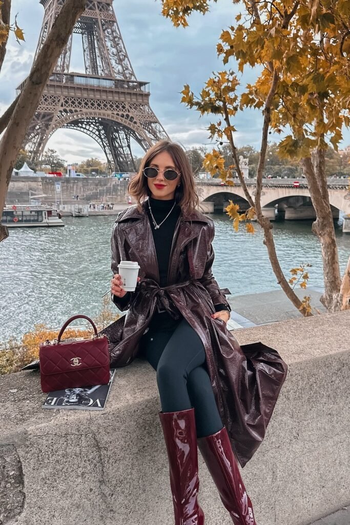 Burgundy Patent Trench Coat + Black Turtleneck + Black Skinny Pants + Burgundy Knee-High Boots + Burgundy Quilted Bag