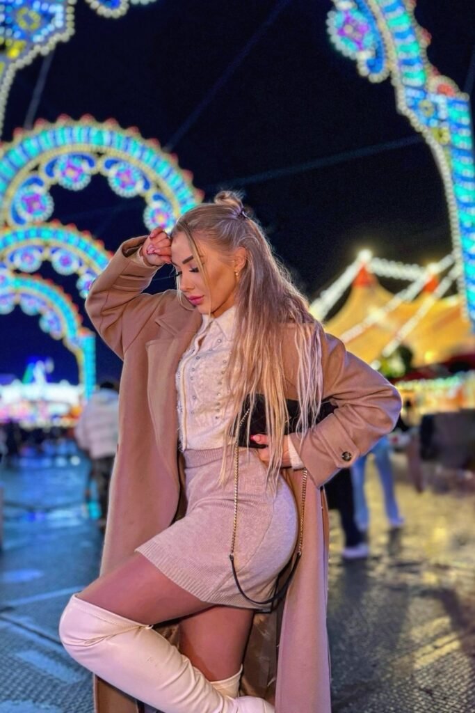 Camel Long Coat + White Ruffled Blouse + Tan Knit Mini-Skirt